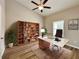 Home office with wood floors, built-in bookcase, and simple decor at 6300 Sw 144Th Lane Rd, Ocala, FL 34473