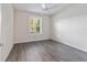 Well-lit bedroom with grey vinyl flooring and window shutters at 6622 Sw 97Th Terrace Rd, Ocala, FL 34481