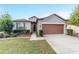 One-story house with a two-car garage and well-manicured lawn at 6622 Sw 97Th Terrace Rd, Ocala, FL 34481