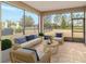 Relaxing screened porch with wicker furniture and backyard view at 6622 Sw 97Th Terrace Rd, Ocala, FL 34481