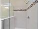 Bright shower with glass enclosure and mosaic tile accents at 6622 Sw 97Th Terrace Rd, Ocala, FL 34481