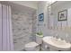 Updated bathroom with marble tile shower and pedestal sink at 8225 Sw 108Th Loop, Ocala, FL 34481