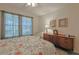 Bedroom with floral bedding, dresser and chair at 8225 Sw 108Th Loop, Ocala, FL 34481