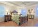 Spacious bedroom with wood flooring and a large bed at 8225 Sw 108Th Loop, Ocala, FL 34481