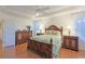 Well-lit bedroom with wood floors and a comfortable bed at 8225 Sw 108Th Loop, Ocala, FL 34481