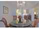 Formal dining room with a glass-top table and chandelier at 8225 Sw 108Th Loop, Ocala, FL 34481