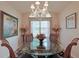 Elegant dining room with a glass-top table and crystal chandelier at 8225 Sw 108Th Loop, Ocala, FL 34481