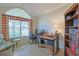 Bright home office features built-in shelving, desk, and comfortable seating at 8225 Sw 108Th Loop, Ocala, FL 34481