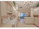 Well-equipped kitchen featuring white cabinetry and a breakfast bar at 8225 Sw 108Th Loop, Ocala, FL 34481