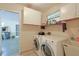 Convenient laundry room with washer, dryer, and ample storage at 8225 Sw 108Th Loop, Ocala, FL 34481