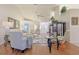 Spacious living room with hardwood floors, comfortable seating, and natural light at 8225 Sw 108Th Loop, Ocala, FL 34481