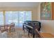 Charming music room featuring a grand piano and large windows at 8225 Sw 108Th Loop, Ocala, FL 34481