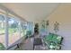Enjoy the outdoors in this screened porch with comfortable seating at 8225 Sw 108Th Loop, Ocala, FL 34481