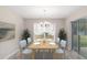 Bright dining room features a wooden table, light blue chairs, and sliding glass doors at 9530 Sw 42Nd Ave, Ocala, FL 34476