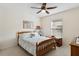 Bedroom with wooden bed frame, mirror, and window with blinds at 9646 Sw 92 Place Rd, Ocala, FL 34481