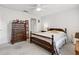 Bright bedroom featuring a wooden bed frame and dresser at 9646 Sw 92 Place Rd, Ocala, FL 34481
