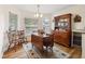 Dining room features hardwood floors, hutch, and wooden table with chairs at 9646 Sw 92 Place Rd, Ocala, FL 34481
