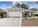 Single story house with white garage door and landscaping at 9646 Sw 92 Place Rd, Ocala, FL 34481