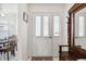 Interior view of a white front door with sidelights at 9646 Sw 92 Place Rd, Ocala, FL 34481