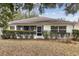 Back exterior view showing a house with a screened porch and landscaping at 9646 Sw 92 Place Rd, Ocala, FL 34481