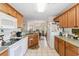 Open concept kitchen with white appliances and wood cabinets at 9646 Sw 92 Place Rd, Ocala, FL 34481
