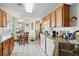Bright kitchen with wood cabinets, tiled floor, and breakfast nook at 9646 Sw 92 Place Rd, Ocala, FL 34481