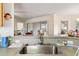 Kitchen sink with stainless steel basin and faucet, overlooking a dining area at 9646 Sw 92 Place Rd, Ocala, FL 34481