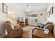 Living room with two recliners, a TV, and wood floors at 9646 Sw 92 Place Rd, Ocala, FL 34481