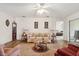 Living room features hardwood floors, a sofa, and access to a bedroom and patio at 9646 Sw 92 Place Rd, Ocala, FL 34481