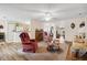 Bright living room with hardwood floors, comfy seating, and a view into other rooms at 9646 Sw 92 Place Rd, Ocala, FL 34481