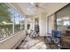 Relaxing screened porch with outdoor seating and view of backyard at 9646 Sw 92 Place Rd, Ocala, FL 34481