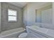 Clean bathroom with shower/tub combo, vanity, and window at 115 Guava Place Dr, Ocklawaha, FL 32179