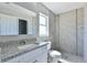 Clean bathroom with granite countertop, white vanity, and tile shower at 115 Guava Place Dr, Ocklawaha, FL 32179
