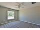 Simple bedroom with large window and ceiling fan at 115 Guava Place Dr, Ocklawaha, FL 32179