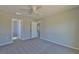 Spacious bedroom with ceiling fan and access to bathroom at 115 Guava Place Dr, Ocklawaha, FL 32179