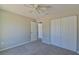 Spacious bedroom with ceiling fan and double door closet at 115 Guava Place Dr, Ocklawaha, FL 32179