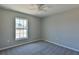 Well-lit bedroom featuring a large window and ceiling fan at 115 Guava Place Dr, Ocklawaha, FL 32179