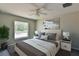 Comfortable bedroom with large window, ceiling fan, and modern decor at 115 Guava Place Dr, Ocklawaha, FL 32179