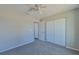 Simple bedroom with ceiling fan and double door closet at 115 Guava Place Dr, Ocklawaha, FL 32179