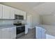 Modern kitchen with stainless steel appliances and granite countertops at 115 Guava Place Dr, Ocklawaha, FL 32179