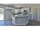 Modern kitchen with island, granite countertops, and stainless steel appliances at 115 Guava Place Dr, Ocklawaha, FL 32179