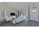 Open living room with vaulted ceiling and neutral decor at 115 Guava Place Dr, Ocklawaha, FL 32179