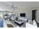 Open living room with vaulted ceiling and neutral decor at 115 Guava Place Dr, Ocklawaha, FL 32179