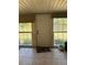 Sunroom with door leading to backyard and large windows at 14788 Sw 39Th Cir, Ocala, FL 34473