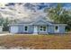 New construction home with blue exterior, white garage door, and stone accents at 16919 Sw 27Th Ave, Ocala, FL 34473