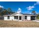 Newly constructed home with a white exterior, black garage door, and stone accents at 16919 Sw 27Th Ave, Ocala, FL 34473