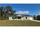 Newly built home with gray exterior, white garage door, and stone accents at 16919 Sw 27Th Ave, Ocala, FL 34473