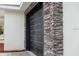Black garage door with stone accent wall at 16919 Sw 27Th Ave, Ocala, FL 34473