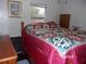 Bedroom with a queen-size bed and wood dresser at 17935 Se 10Th Pl, Silver Springs, FL 34488