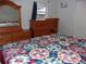 Large bedroom with wooden dresser and king-size bed at 17935 Se 10Th Pl, Silver Springs, FL 34488